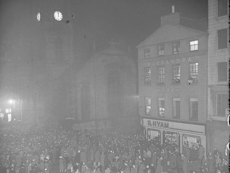 Hogmanay scenes at the Tron Church in Edinburgh with the Alexandra Hotel and B Hyman store in the background in 1956.