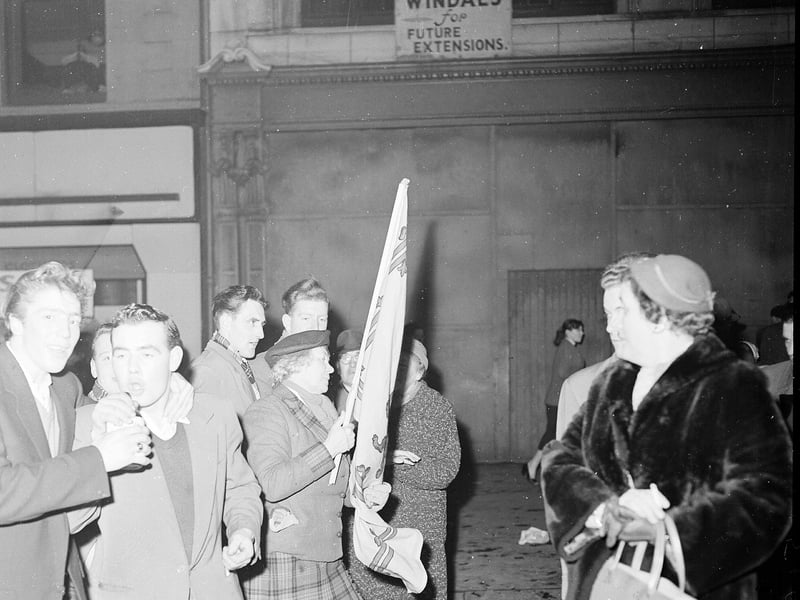Wendy Wood at the Tron on Hogmanay 1957 with a Scottish  Standard flag.