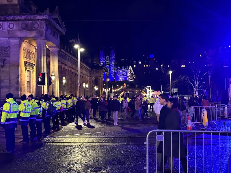 Security personnel are in place as people begin to gather near the National Gallery