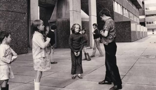 Children play outside the flats in August 1971.