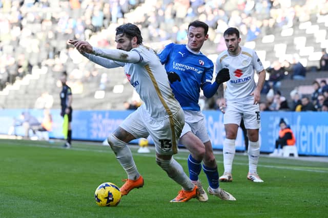 For a second game in a row, Dons conceded in stoppage time to drop points to a potential promotion rival