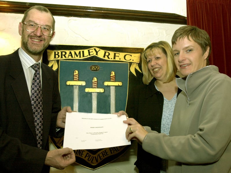 John Battle MP signs up for the first share certificate in the new Bramley RLFC  given to him by two of the new directors  Helen Colbeck, left, and Vanessa Burnley in front of the Bramley shield at the  Old Vic pub.