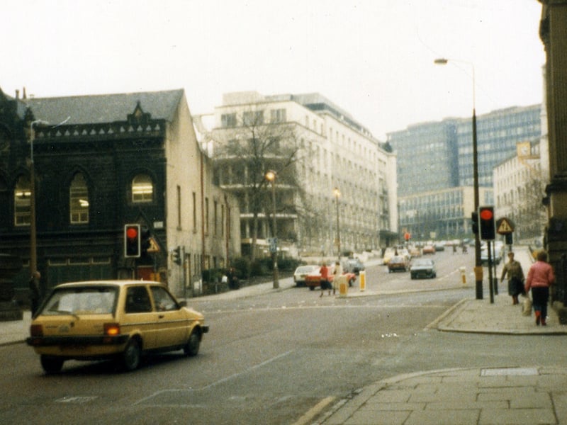 Calverley Street showing the junction with Alexander Street on the right. Just beyond this, the edge of the Education Offices can be seen. In the background are the Brotherton Wing of Leeds General Infirmary and buildings of Leeds Polytechnic.