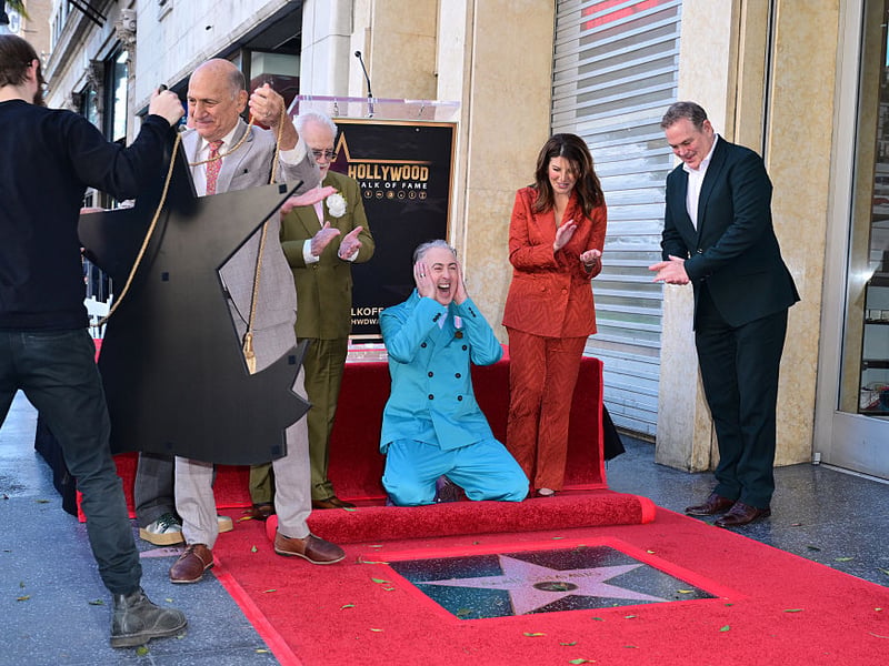 Scottish actor Brian Cox (3rd L) and US activist Monica Lewinsky (2nd R) cheer as Scottish actor Alan Cumming (C) reacts as his Hollywood Walk of Fame star is unveiled during a ceremony on January 8, 2026 in Hollywood, California.