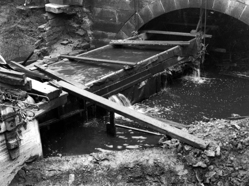 Close up of Hol Beck under a stone bridge near Water Lane, showing part of the construction of an extension to R W Crabtree and Sons. Pictured in November 1944.
