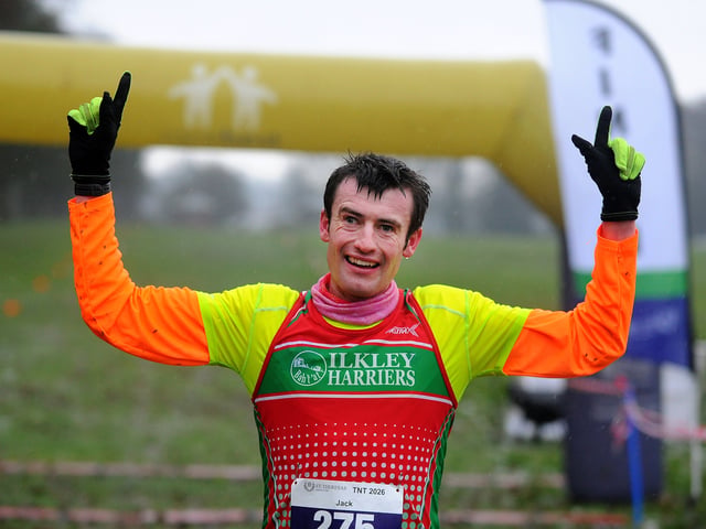 Jack Cummings, number 275 who led from start to finish,   celebrates at the finish line. 