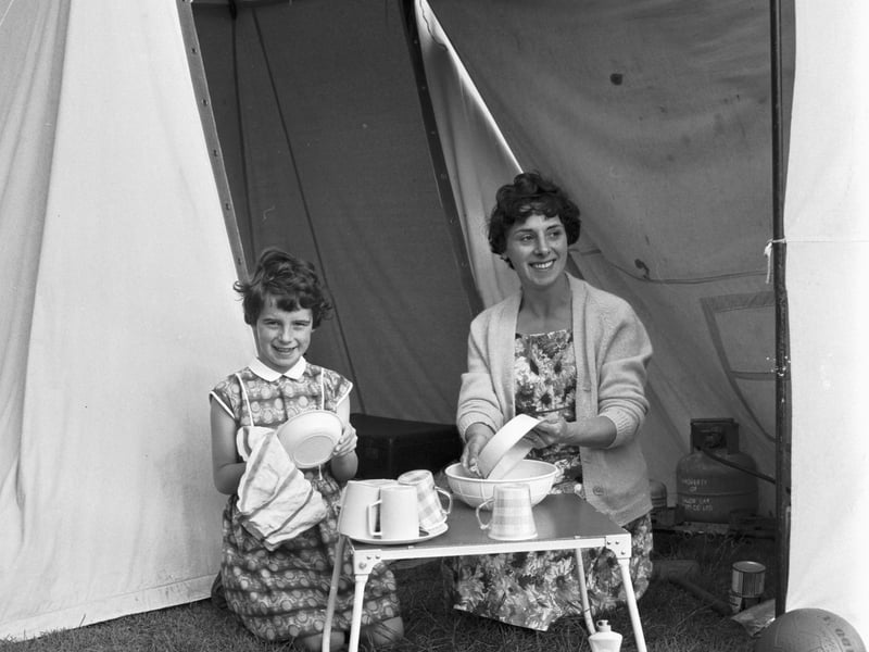 A mum and daughter wash the dishes outside their tent at the Granton campsite on Marine Drive in July 1966.