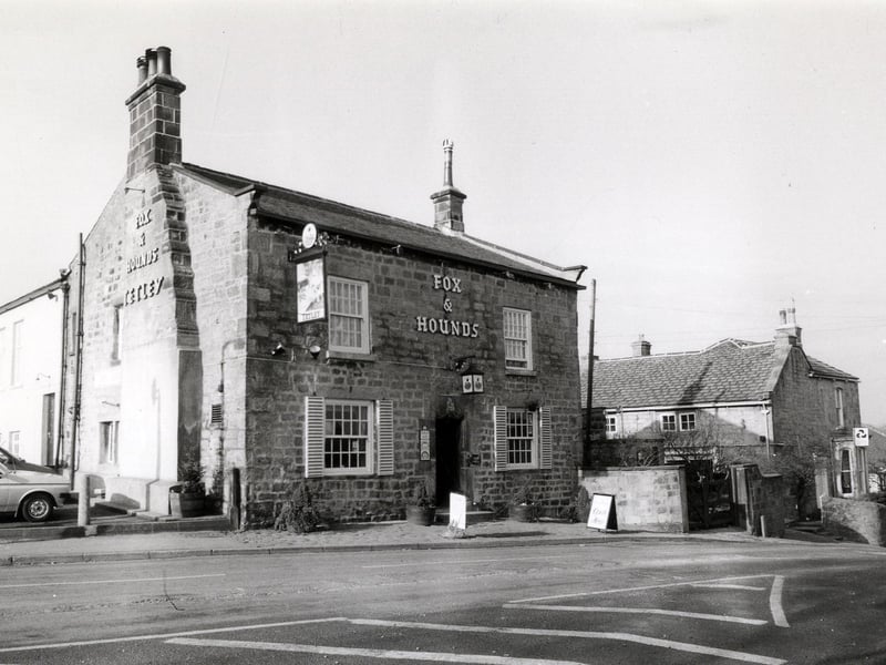 The Fox and Hounds pubat the Cross on Church Hill, a traditional stone built inn believed to date back to 1728. The National Westminster Bank is on the right.