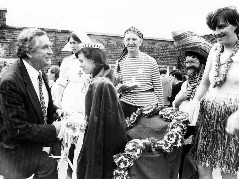This photo taken at Gipton Gala on July 5, 1986. It shows Denis Healey MP crowning Ann Marie Duffy the Queen of Gipton Gala watched by local people in fancy dress costumes. Denis Healey went down on bended knee to present the Queen with a Silver cup. Her attendants, Princess Katie Manning and Prince Shane Bosomworth were also presented with a gift.
