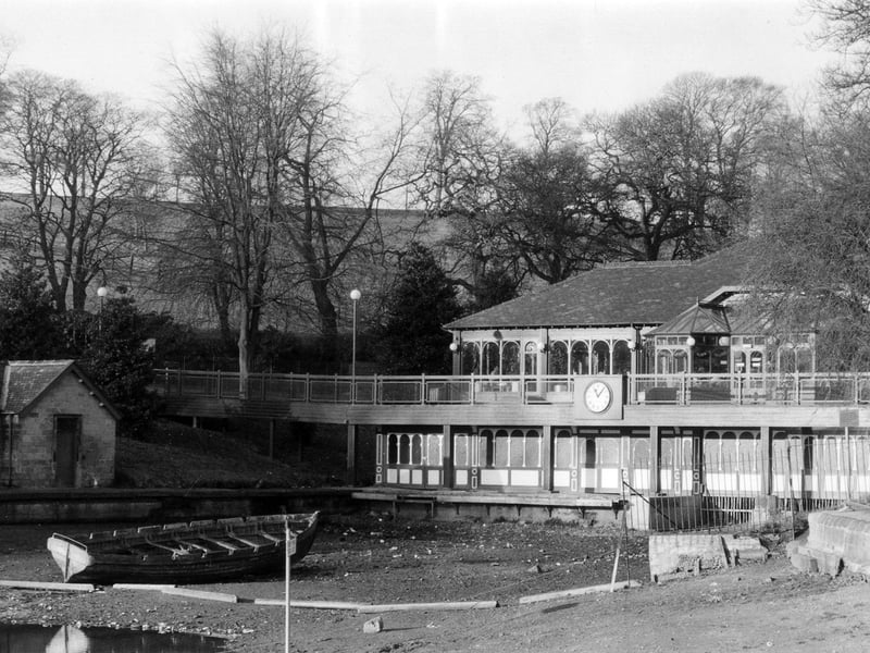 The Lakeside Café possibly taken at the time that it was being converted into a café from the former boathouse. The edge of Waterloo Lake in front has been drained of water and a lone boat sits at the bottom.