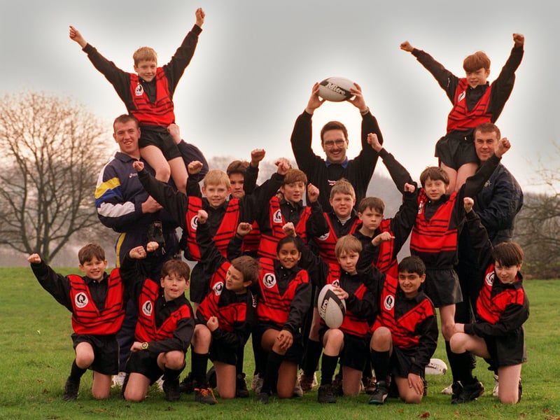 Members of Weetwood Primary School rugby team celebrate after receiving a new rugby kit. They are pictured with, back from left, Leeds RL star Nick Fozzard and PE teacher Kevin King.