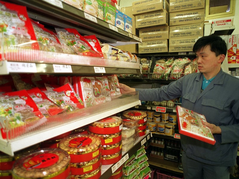 Derek Hoy of the Wing Lee Hong supermarket in Leeds stocks shelves as the store gets ready for the Chinese New Year.