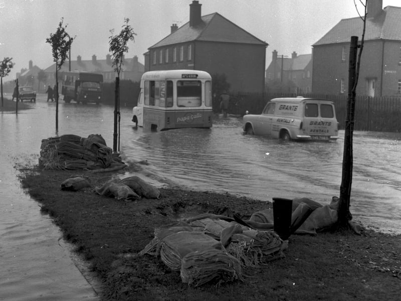 Two vans trapped by floods in Broomhouse Road in October 1965.