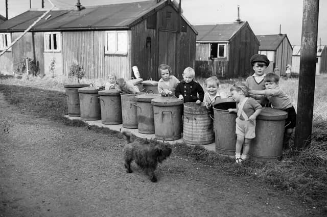 Sighthill Camp children playing with rubbish bins in 1954.