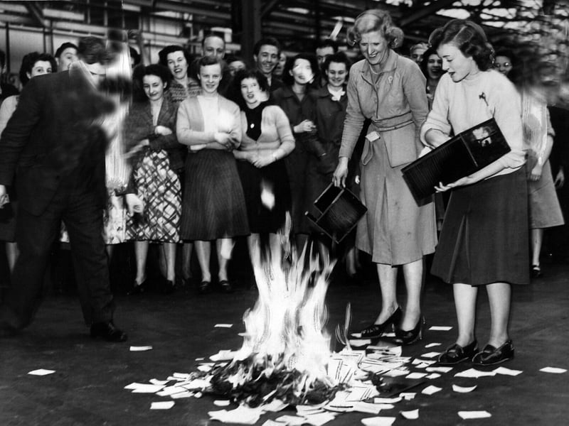 Clerks employed at the showrooms of Appleyard of Leeds, Ltd. are pictured burning 20,000 gallons of petrol - on paper - at the showrooms in May 1950. Coupons and correspondence associated with petrol rationing.