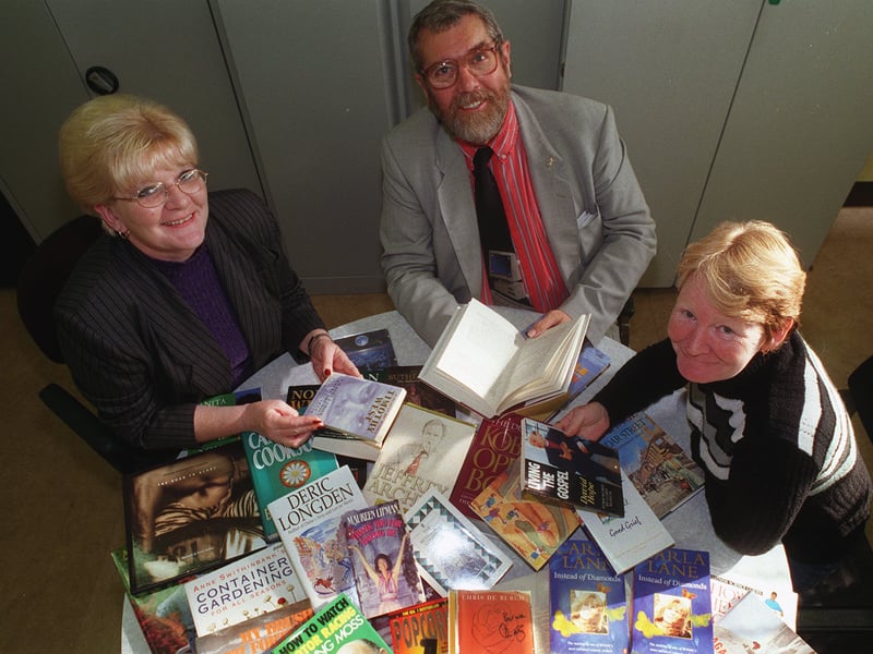 The Marmaville hosted a celebrity book auction in October 1999. Pictured are Bob Dudley with Moira Blakeley, left, and Shirley Duchesne, and some of the books.