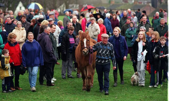 January 1999 and a rally in protest over plans to build 130 new homes in the town was staged. Pictured leading the protest is Milton Scott with 'Sunny'.