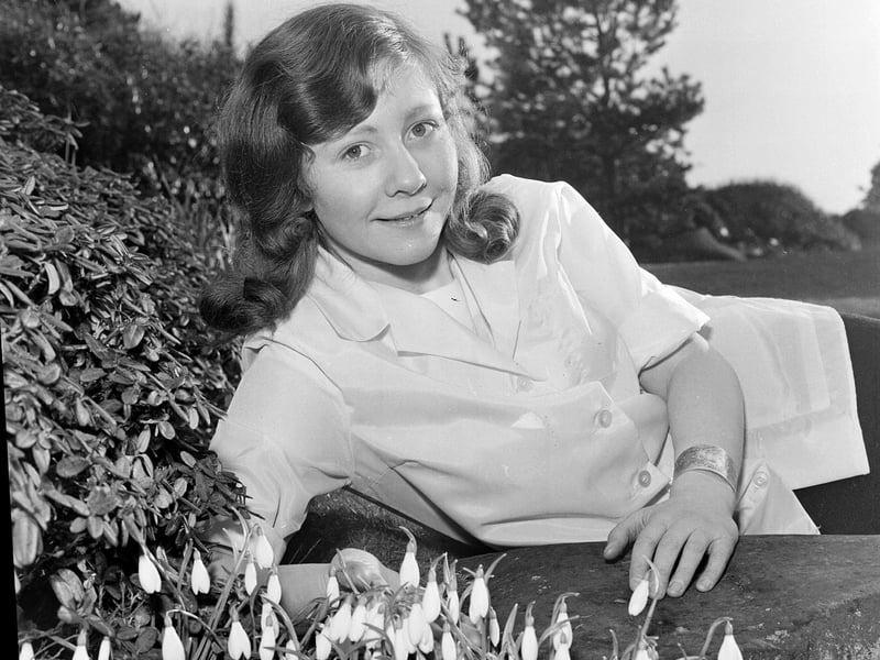 Helena Mary Turner admiring snowdrop in the Botanic Gardens in February 1964.