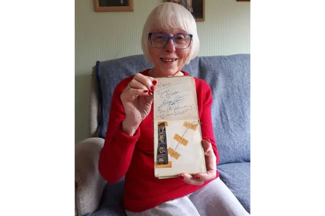 Elizabeth Salt, 79 of Lichfield, with her autograph book stuffed full of 60s icons that she collected as teenager in Portsmouth.