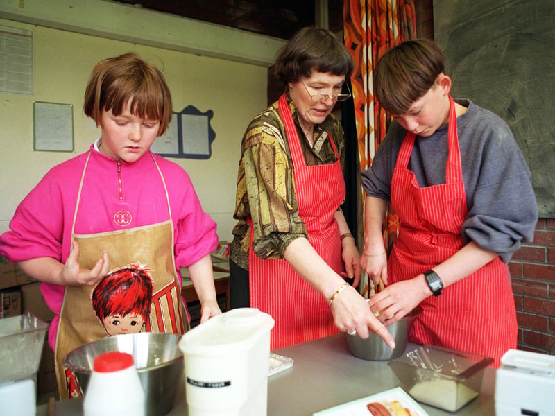Joan Normington, headteacher at Westfield School, pictured with two of her pupils in a cookery class in May 1996.
