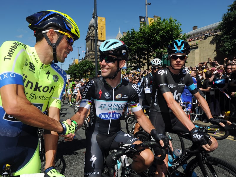 Mark Cavendish, centre, shakes hands with Alberto Contador, left, and Chris Froome at the start.