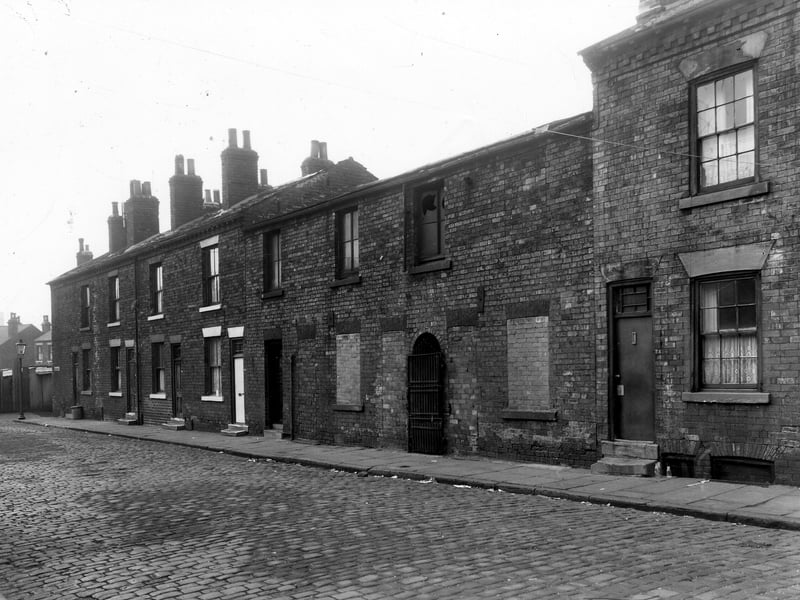 A section of Greystone Street in November 1959. Between 17 and 21 the houses have been bricked up, the iron gate in the centre is blocking an alleyway which led to the back of the houses.