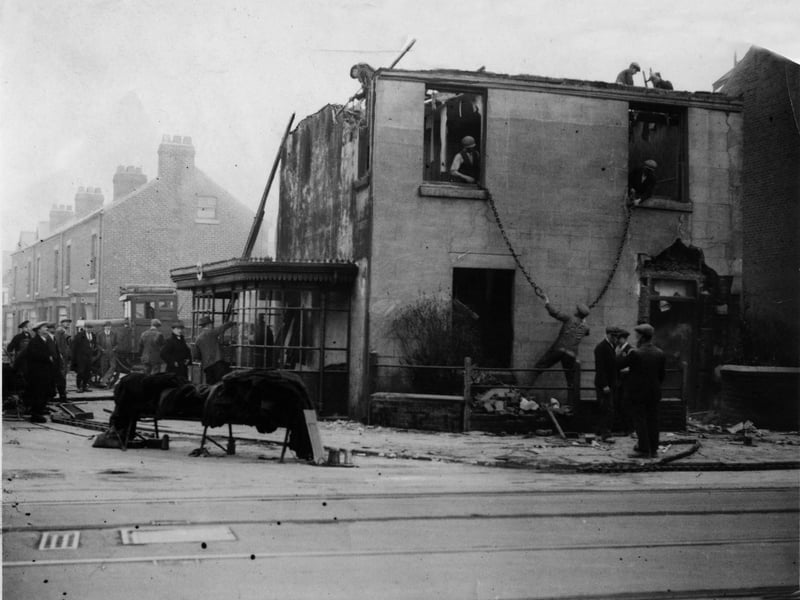 In the name of progress - once Blackpool's motto - another building prepares to bite the dust in 1928. Workmen are seen fastening heavy chains to the bedroom window frames of this cottage as demolition continues apace at the junction of Watson Road and Lytham Road, South Shore