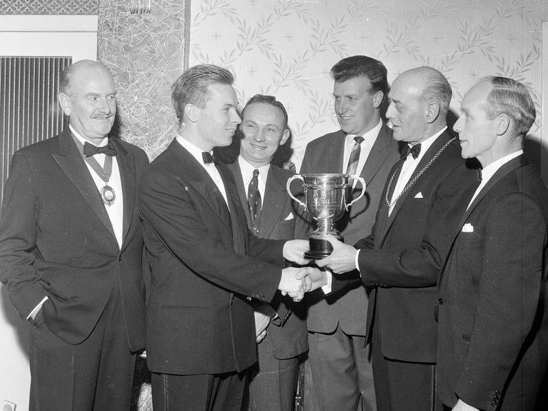 AM Brown, the Champion of Musselburgh Golf Club, is presented with his award from Provost Arthur in November 1964.