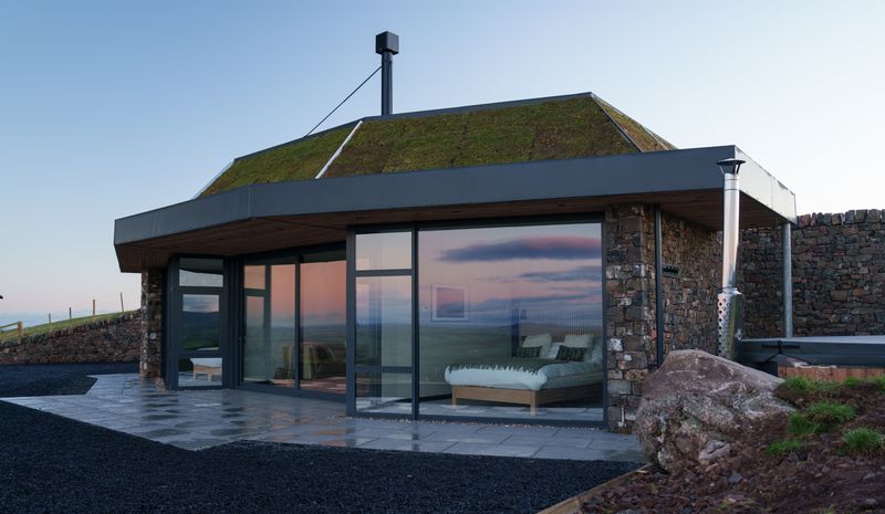 The retreat is exquisitely crafted from local stone and wood, and boasting a green roof strewn with seasonal wildflowers.