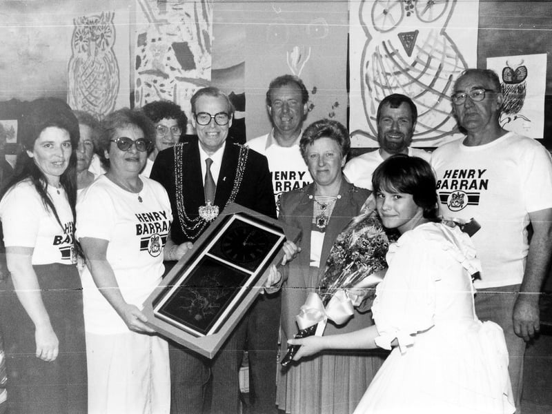 A group photograph taken at the Henry Barran Centre on the occasion of its Golden Anniversary in July 1988. The Lord Mayor, Councillor Arthur Vollans is pictured presenting his gift of an ornamental wall-clock to the Henry Barran Centre Management Committee.