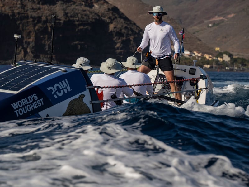 Royal Navy sailors aboard HMS Oardacious finished "the world's toughest row", a trek of 3,000 miles from the Canaries to Antigua.