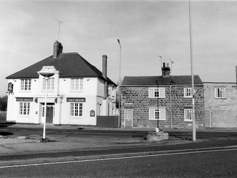 Harewood Road seen from the junction with Leeds Road. The Half Moon Inn, a John Smith's public house, is on the left while a cottage at no. 1 is towards the right. The present Half Moon building dates from 1900; a much older original building adjoining it on the left was demolished to make room for a car park.