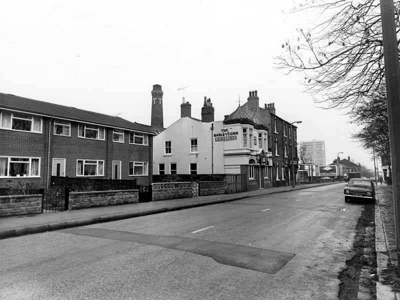 Looking east along Town Street in November 1981, with the Barleycorn pub in the centre. On the left are houses numbered 120-116. Behind the pub an industrial chimney bearing the letter T can be seen. In the distance on the right is the junction with Armley Ridge Road and beyond this the tower block of Burnsall Croft.
