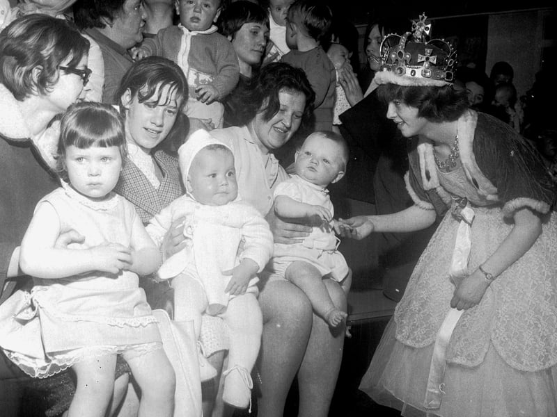The Fair Queen judges the Bonnie Babies competition at the May Fair in Pilton in May 1966.