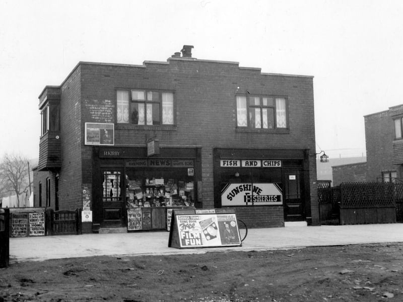 Two shops with living quarters on Whitehall Road pictured in November 1938. No.385 on the left is a newsagents, H.Kirby, no.387 is a fish and chip shop 'Sunshine Fisheries' business of George Brown. The advertising board on the pavement carries a poster for 'Film Fun' comic with a free George Formby songbook.