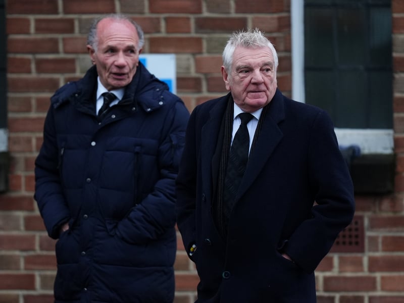 Former Leeds United teammates Paul Reaney (left) and Stix Lockwood arrive at the funeral.
