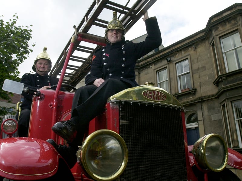 Firefighters Chris Stark and Susan Menelaws from Tollcross station on their 1930's vintage Dennis fire engine visiting the Royal Hospital for Sick Children, in September, 2002. 