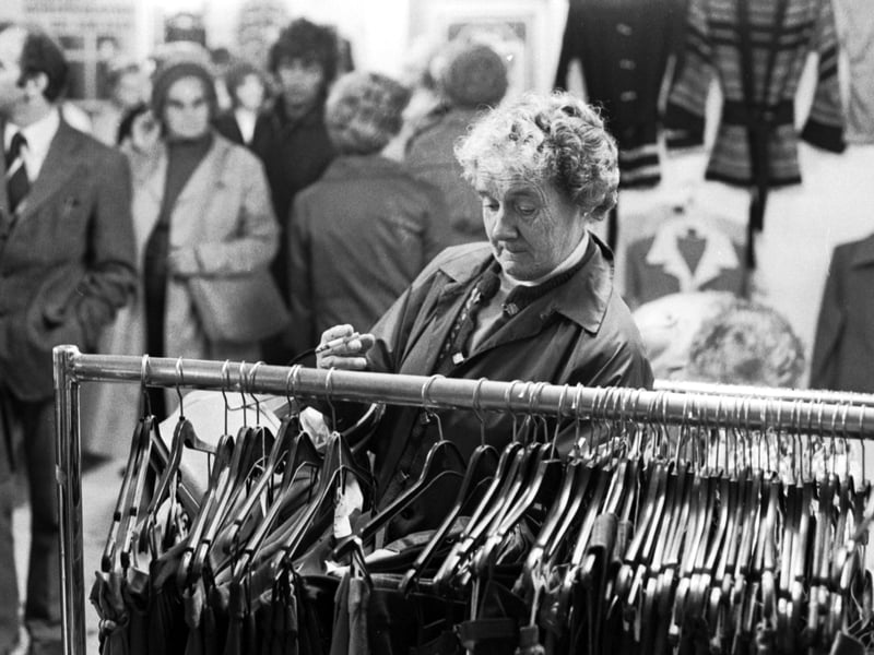 A woman looking at a clothes stall in a market at Earl Grey Street, Tollcross, Edinburgh, in September 1976.
