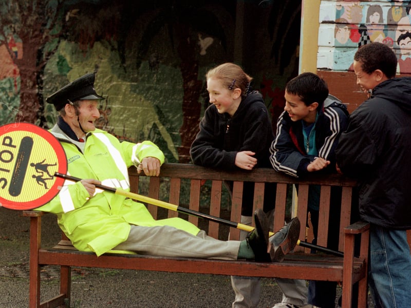 Tollcross Primary 89 year old lollipop man Harry Young taking a rest three weeks after retiring in November, 1999, pictured with pupils from the school.