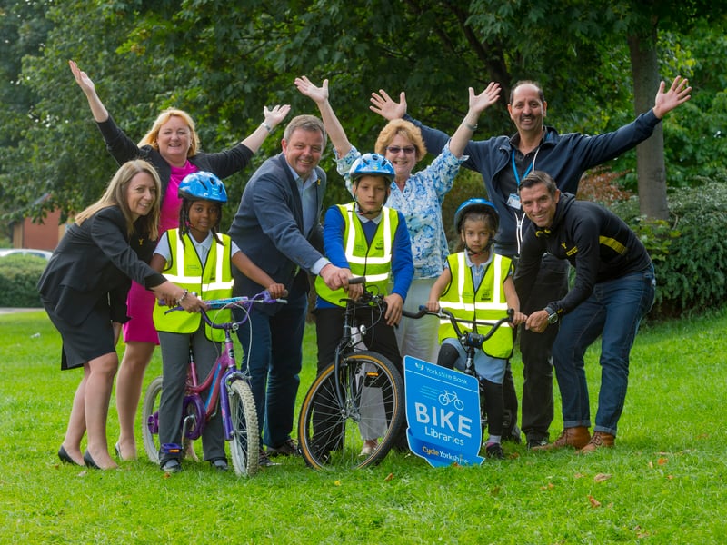 September 2016 and Yorkshire Bank, Welcome to Yorkshire and Leeds City Council officially opened their fourth Yorkshire Bank Bike Library at the One Stop Centre on Dewsbury Road. Pictured, from left, are Jacqui Atkinson, Yorkshire Bank partnerships manager, Coun Debra Cooper, Peter Dodd, commercial director of Welcome to Yorkshire, Coun Angela Gabriel, Coun Mohammed Iqbal, and former professional cyclist Dean Downing, with pupils from New Brewerley Community Primary School.