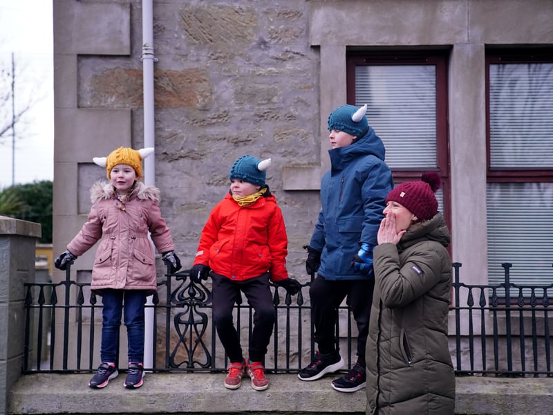 Children watch the Jarl Squad parade through the town.