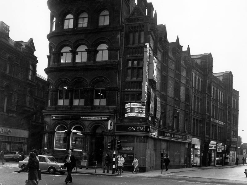 Boar Lane from Albion Street, showing in the centre, no. 22 the National Westminster Bank and no. 23, formerly Owen & Robinson, jeweller, now advertised as sold. On the left is Alfred Street, with Dunn & Co, menswear, on the corner at no. 21 Boar Lane. On the right is New Station Street, with Ardente Hearing Service, the Wimpy Bar Restaurant, Nicky & Carlo gents hairstylists and Spensley and Gough light clothing manufacturers to be seen. Taken in the mid-1970s.