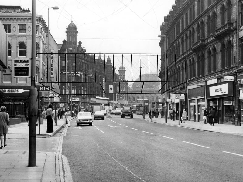 Looking east along Boar Lane, taken in the mid 1970s. On the left is C & A, then hidden from view Holy Trinity Church, followed by Richard Shops ladieswear. Further along is the junction with Briggate. Shops on the right include Finlay's tobacconist (partly visible on the far right), Stone-Dri weatherwear, at number 12, and temporary premises of Rawcliffe's clothiers whose store on Duncan Street is undergoing renovation; this is just visible in the distance.