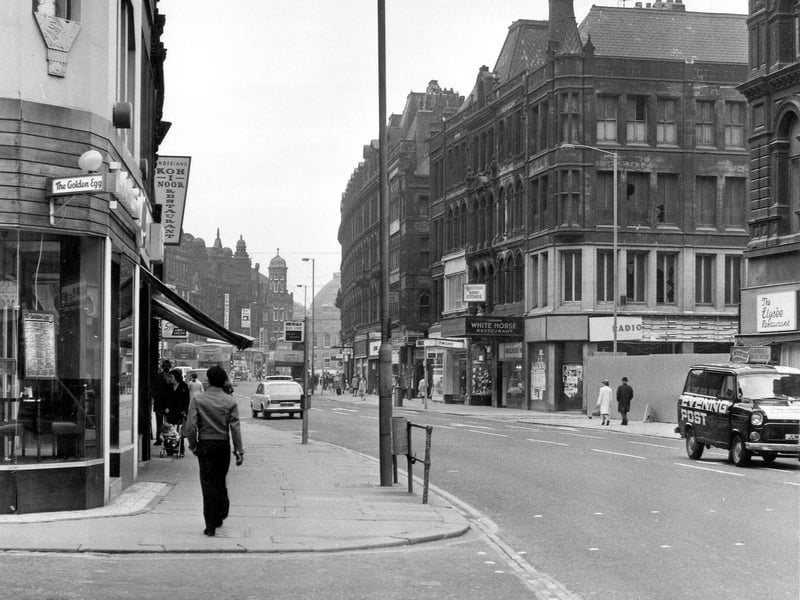 Boar Lane looking east, taken in the mid-1970s. In the foreground is the junction with Albion Street. On the left are the Golden Egg restaurant and the Koh-i-noor restaurant. On the right are the Elysee restaurant, the junction with Gascoigne Street, a vacant shop that was formerly Radio Rentals, Silvio's Bakers and the White Horse restaurant, followed by Wakefield's Army Stores and Finigan's ladieswear.