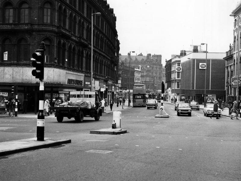 Boar Lane looking west, seen from Duncan Street with the junction with Briggate on the left. Alexandre menswear is on the corner, with the White Rose Restaurant next to this. On the right are Richard Shops ladieswear and C & A, with Holy Trinity Church out of view in between. Taken during the mid-1970s.