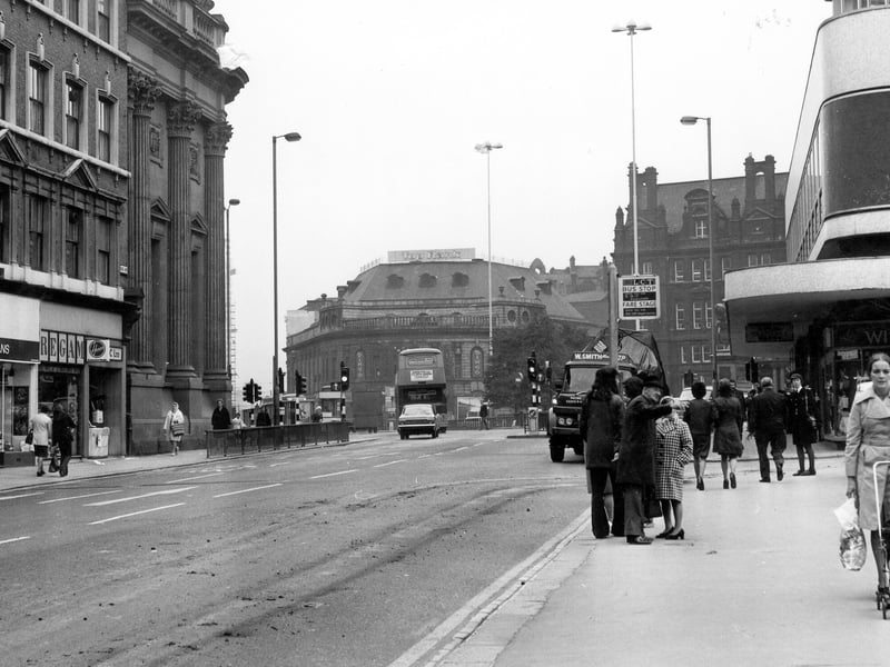 Boar Lane, looking west towards City Square, taken in the mid 1970s. On the left are Bellmans knitwear, Regam electrical cleaner service and the Midland Bank. On the right is Royal Exchange House, with shops at the bottom including Wiltex, ladieswear. City Square is in the background, with the former Majestic Cinema, then occupied by Top Rank Bingo, and the General Post Office building, around it.