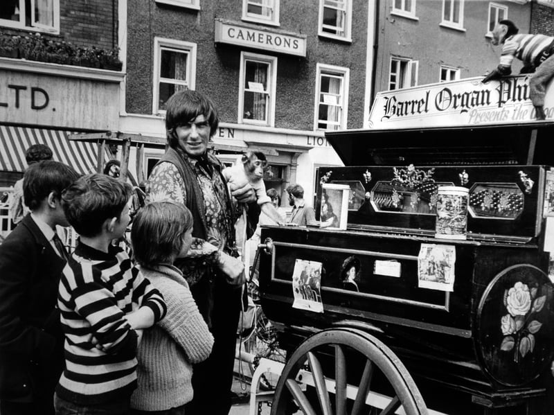 York. 22nd July 1971Boys gather round Phil, the barrel organ man, who, with his monkeys, is performing in St Sampson's Square, York, in July 1971