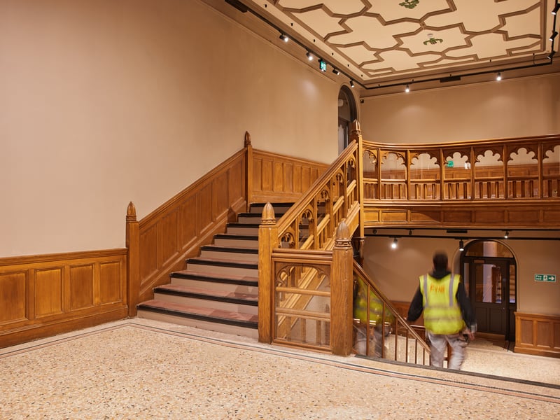 Refreshed main staircase with hand-painted ceiling detail.