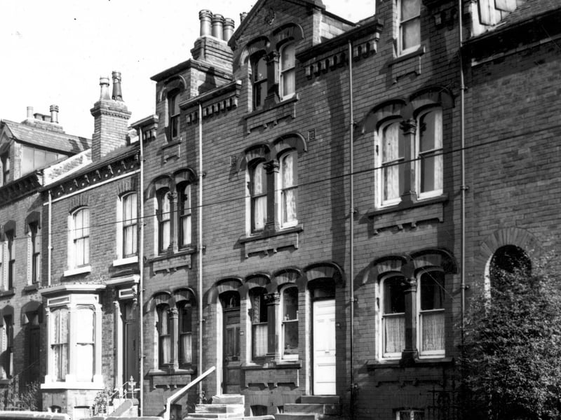 A row of through terraced houses each with a small private garden to the front on Westfield Road. The building in which numbers 116 and 118 are located has decorative stone work around the windows and above the dormer windows. Pictured in November 1967.
