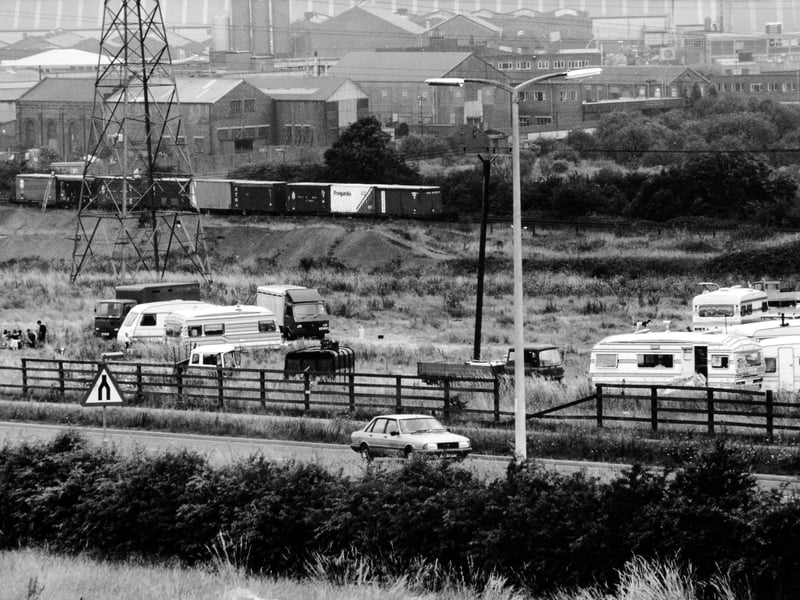 Caravans and trailers from the gypsy and traveller community in August 1991. The roadside site is located near railway wagons containing chemicals